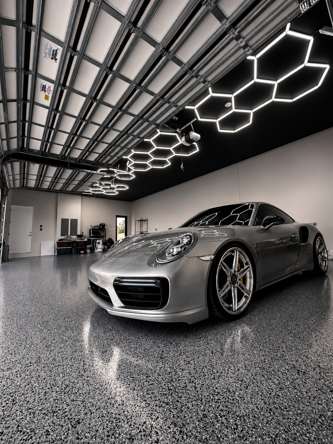 Porsche in a garage with hexagon LED lights